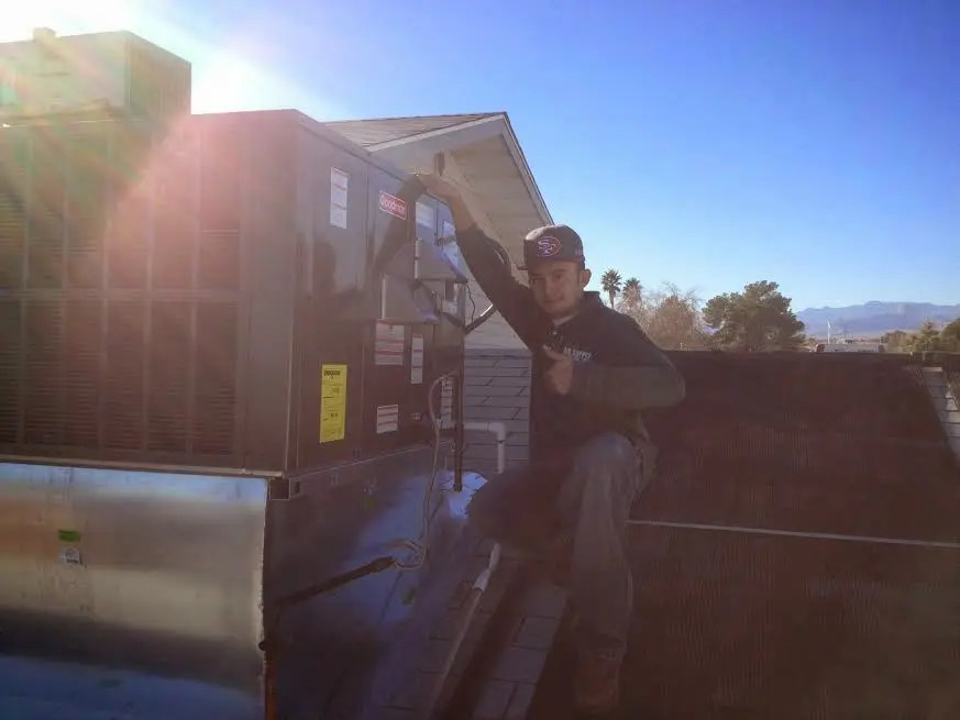 HVAC technician performing HVAC Inspection on a rooftop unit in University City